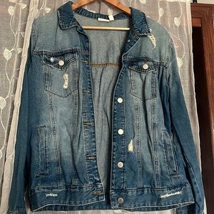 Distressed jean jacket, loose fit.